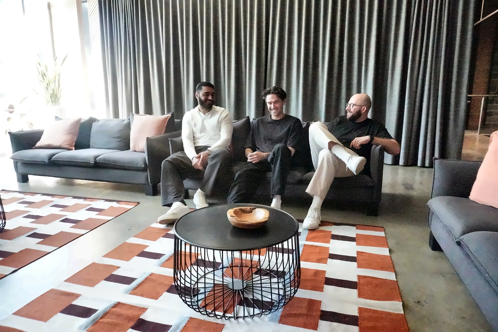 Khodar, Rhys and Lorenzo sitting on the office sofa