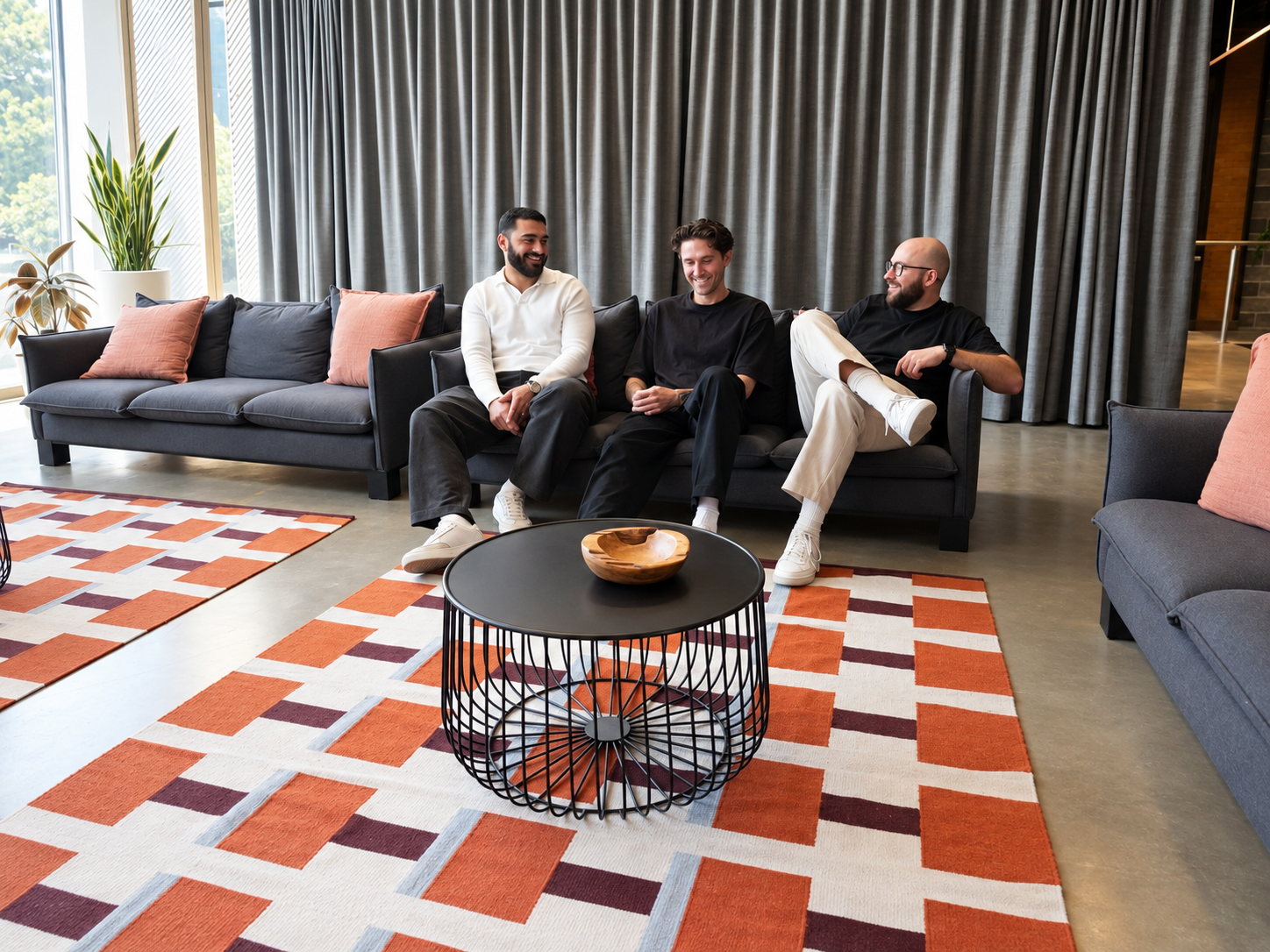 Khodar, Rhys and Lorenzo sitting on the office sofa