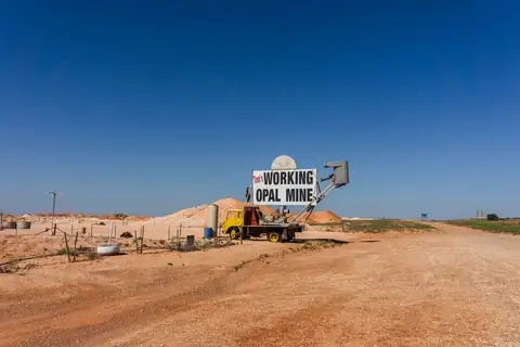 Opal mine entrance and machinery on red dirt at Coober Pedy