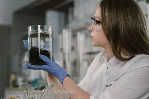 Scientist in gloves checking a water sample in a lab